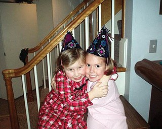 EMILY ZIMMERMAN and Madalyn Smith share a friendship hug on New Year’s Eve.