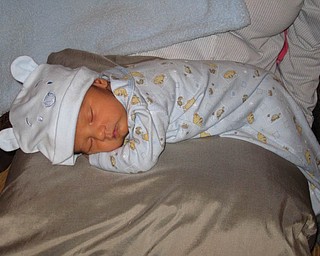 MATTEO JALEN SKURICH is only eight days old here. He is sporting his favorite hat — a Winnie the Pooh blue cap. He is the son of Ruth and Matthew Skurich.