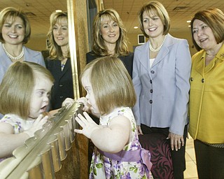 <p>REFLECTING: As they prepare for the Angels of Easter Seals fashion show and luncheon on May 14 at Mr. Anthony’s in Boardman, from left, Deborah Liptak, Angels president; and Jill Chesney and Mary Celeste Van Sickle, chairs of the event, share a moment with Marina Donadio, 3, who is intrigued by her mirrored reflection.</p>