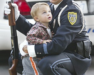 Youngstown Police Dept.Honor Guard member Anthony Marzullo shares a moment with his son Anthony Michael Marzullo, 22 months, during 9/11 ceremony on the green in Canfield Sept. 11, 2008.