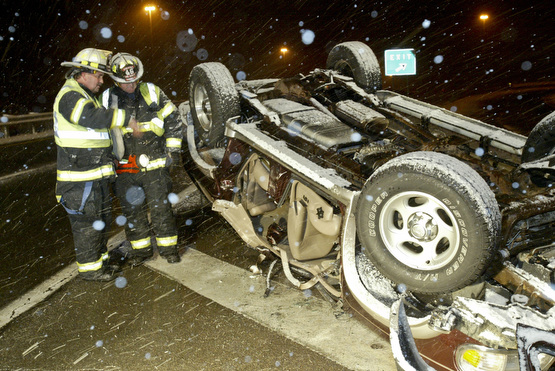 Vienna Fire Dept Assist Chief Mike Hagood, left, and EMT John Hinely look over an accident scene on Route 11 November, 17,2008. They said a motorist was southbound on 11 and lost control on a bridge near the Rt 82 interchange and rolled the vehicle. The d river was taken to an area hospital. The Vindicator/William D. Lewis