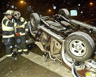 Vienna Fire Dept Assist Chief Mike Hagood, left, and EMT John Hinely look over an accident scene on Route 11 November, 17,2008. They said a motorist was southbound on 11 and lost control on a bridge near the Rt 82 interchange and rolled the vehicle. The d river was taken to an area hospital. The Vindicator/William D. Lewis