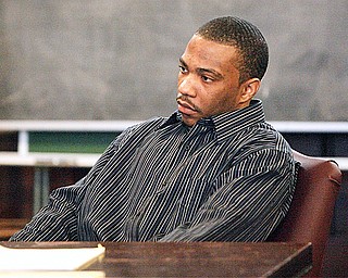 Curtis Young watches as the trial in Maureen Sweeney's courtroom gets underway Monday Morning. Curtis Young, 26, is charged with the July 31, 2007, aggravated murders of his ex-girlfriend, Helen Moore, 29, her full-term fetus, and her 8-year-old son, Ceonei.