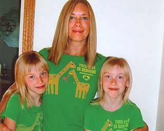 Kim Patton, 44, with twin 10-year-old daughters, Emily Hawkins, left, and Lily Hawkins, all of Columbiana.