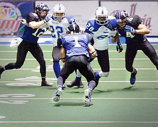 The Mahoning Valley Thunder's Quorey Payne (1) takes the ball down the field as he runs into teamates Chris Schubert (12) and C.J. Brewer (4) and Pioneers William TuTu Ferguson (22) and Allan Barnes (28) during the fourth quarter of the game at the arena formerly known as the Cheverolet Centre on Friday evening.