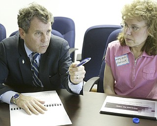 US Sen Sherrod Brown talks with Mary Hudzik of Warren, a member of Delphi Salaried Retirees Association, during a meeting concerning Delphi retirees benefits Monday at the UAW 1112 hall in Lordstown.