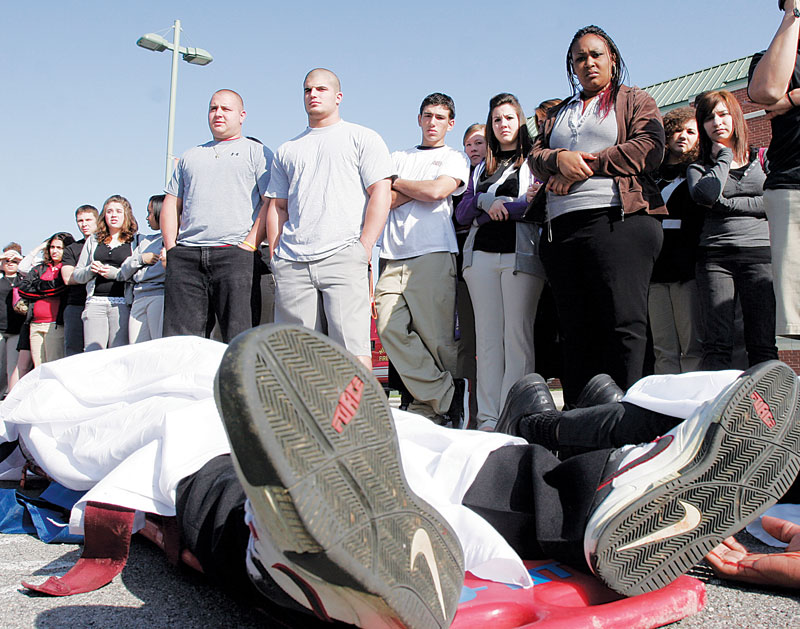 PLAYING DEAD: New Castle High School senior Ta’Shan Jones was one of several students from the school to portray an accident victim during a mock crash Tuesday. The event was designed to demonstrate the dangers of drinking and driving.