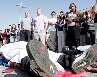 PLAYING DEAD: New Castle High School senior Ta’Shan Jones was one of several students from the school to portray an accident victim during a mock crash Tuesday. The event was designed to demonstrate the dangers of drinking and driving.
