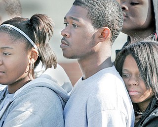 WATCH AND LEARN: New Castle High School seniors Lynette Fish, left, Tyrell Booker and Jaylynn Gardner watch a mock accident. The message was not to let prom celebrations include drinking and getting behind the wheel. Wear seat belts, too.