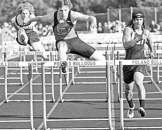 Canfield Tyler Mettille (red) places first in the Boys 110 Meter Hurdles with Howland Dante Marsh, on right, trailing right behind him at Poland High School, Tuesday May 12, 2009.