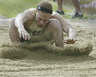 Harding's Desmond Reed lands during long jump at Chaney meet Thursday.