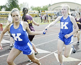 JFK's Kelli Gaurneni, left, takes hand off from Meghanne Perisa during final leg of 4X800 at Chaney Thursday. In background Mooney's Dina Daltorio hands off to Alex Sierra. JFK won, Mooney came in 2nd.