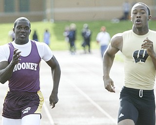 Mooney's Matt MCWilson, left, and Harding's DeAver Williamson go for the finish line in a 100 semi final Thursday at Chaney. Williamson won the semi final