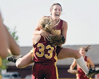 Cardinal Mooney's Cadi Sheffler (11) leaps into the arms of Shayla Decapita (33) after defeating Canfield in softball at Boardman's Field of Dreams on Thursday evening.