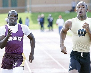 Mooney's MAtt McWilson, left, and Harding's DeAver Williamson go for the finish line in a 100 semi final Thursday at Chaney. Williamson won the semi final.