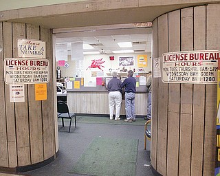 USING THE OFFICE: Two people take advantage of services offered at the Bureau of Motor Vehicles office in Hubbard. The office has been given one year to increase the number of patrons using the facility, or the state will no longer renew its contract.