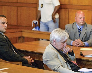 FOUND GUILTY: Former Trumbull County deputy sheriffs Anthony Leshnack, left, and Peter Pizzulo wait in common pleas court after entering no-contest pleas to a felony charge of grand theft. In the center is J. Gerald Ingram, who represented Leshnack. A judge found both men guilty Friday. They will be sentenced later.