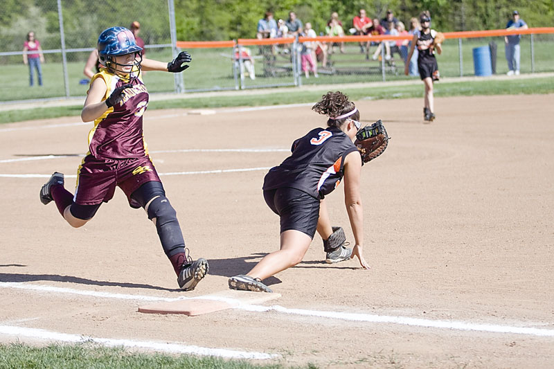 South Range Emily Seman (32) gets out by Springfield Rebecca Evan (3) at first base during the first inning Friday.