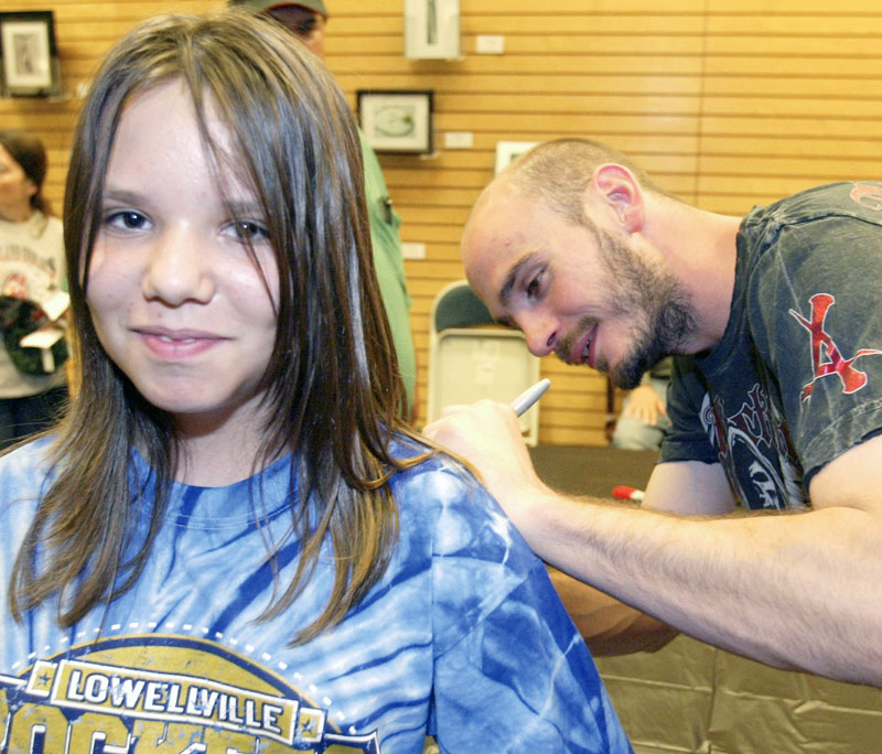 LUCKY LADY:  Lauren Zetts, 10, of Campbell has her shirt autographed by middleweight boxing champion Kelly “The Ghost” Pavlik at a signing for his biography. Pavlik and the book’s co-authors, David Lee Morgan and Greg Gulas, were on hand at the Boardman Barnes & Noble on Friday for the signing.