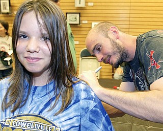 LUCKY LADY: Lauren Zetts, 10, of Campbell has her shirt autographed by middleweight boxing champion Kelly “The Ghost” Pavlik at a signing for his biography. Pavlik and the book’s co-authors, David Lee Morgan and Greg Gulas, were on hand at the Boardman Barnes & Noble on Friday for the signing.