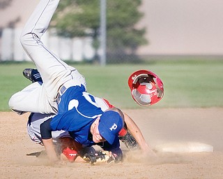Poland's Phil Lipari (10) lands on top of Niles' Nick Harper (1) after making the catch at second base where Harper was called out ending the top of the seventh inning at Cene Field in Struthers on Monday evening.
