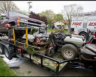 5.13.2009
Ohio State Highway Patrol, Struthers Fire Department, Sturthers Police, and Poland Fire Department respond to an accident where a man drove his pickup truck up onto a trailer pinning a a man who was sitting on a riding lawn mower in Struthers on Wednesday afternoon. The driver of the pickup was driving south bound on Fifth Ave. and is being charged with Operating a Vehicle while Intoxicated, the lawn mower operator was taken by Clemente-McKay EMS to St. Elizabeth's Hospital narrowly escaping major injury.