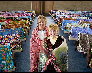 5.13.2009
Blankets take the seats of the congregation that made them as Diane Wise and Wanda Marland wear two of the 117 blankets made by their fellow members of Western Reserve United Methodist Church for delivery to Berea Children's Home and Sojourner House. The congregation spent about a month making the blankets that will be given to infants, children, teenagers and battered women.