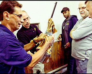 5.13.2009
Youngstown police officers inspect a rifle received during the Youngstown Gun Buy Back program at the downtown department.