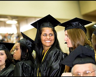 Students stand to accept their degrees during Youngstown State University's Undergraduate Commencement, Saturday May 16, 2009.