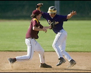 5.19.2009
South Range's Vince Miller tags Champion's Rick Yauger on his way to third base during the bottom of the fourth inning at Cene Park on Tuesday evening.
Geoffrey Hauschild