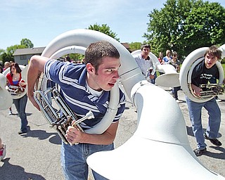 TILT AND PLAY: Trevor Bunevich a senior dips the tuba as the band practices. The Boardman High School Band has been invited to play for the 100th running of the Indianapolis 500.