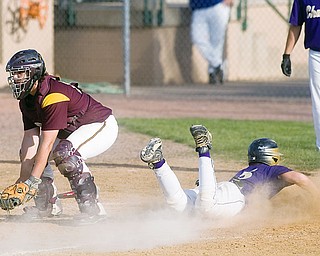 South Range's Chris Gause waits for the throw while Champion's Rick Yauger scores the final run for the flashes in the bottom of the fith inning at Cene Park on Tuesday evening. Yauger's run brought the final score to 13-3 Champion.