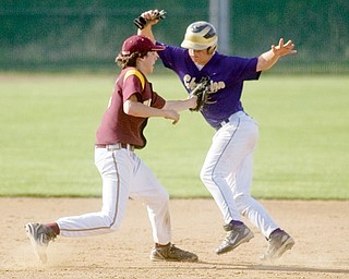 South Range's Vince Miller tags Champion's Rick Yauger on his way to third base during the bottom of the fourth inning at Cene Park on Tuesday evening.