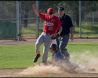 5.20.2009
McDonald's Mike Thomas (3) slides safe into third base as Columbiana's Tyler Denmeade (12) lands after making the catch during the bottom of the fourth inning at Cene Field on Wednesday afternoon. 
