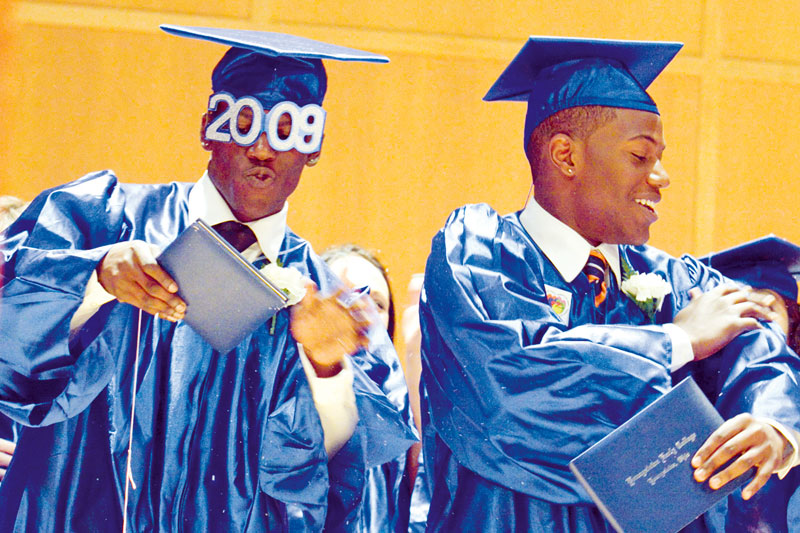 Twin brothers James A. Davis III, left, and Justin A. Davis, right, both 18, brush off confetti and silly string during a celebration onstage for their graduation of Youngstown Early College. The Class of 2009 Commencement was held at DeYor Center, Wednesday May 20, 2009.