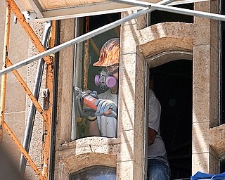 Steve Yates of Kansas and Bovard Studio Inc, of Iowa.. works on the grout as the stained glass windows are removed - and restored and replaced - at the Cathedral on Wood St.