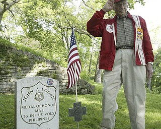 Raymond Braidich a WWII Marine veteran from Poland salutes a flag on the grave of Maj. John A. Logan. A group of veterans and volunteers decorated graves there.  Maj. Logan is son of General John A. Logan who issued General Order11 at the end of the Civil War resulting in Decoration Day and then Memorial Day.