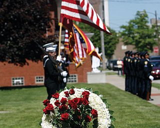 Officers of the YPD honor guard under the direction of Robin Lees fire a 21 gun salute to fallen officers.