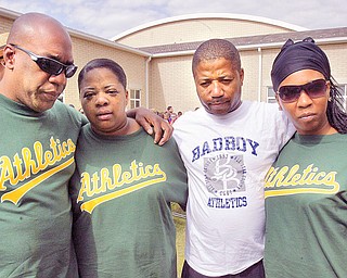 The family of Lloyd McCoy Jr., a 6th grade shooting victim, embrace during a ceremony at Willard School in Warren Friday where he was a student. From left to right, they are his father, Lloyd McCoy Sr., his mother, Pamela McCoy, uncle David Williams and sister Brittnay McCoy.
