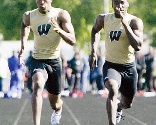 Harding's DeAver Williamson, left, edges out Harding's Joseph Threats to win boys 100-meter dash Friday, May 29, at Austintown Fitch.