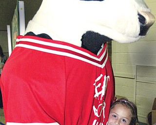 Allyson Andrews, Dobbins Elem School, Poland gets a hug from the Chik-Fil-A cow during a visit to the school Monday. Dobbins was one of 10 school sin the country to win Chik-Fil-A Core Essentials program.