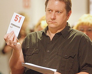 Bill Stiles of Youngstown - or #51- puts in a winning bid at the Youngstown Playhouse as items deemed no longer needed were sold to the highest bidder Tuesday morning at the Playhouse on Glenwood Avenue.