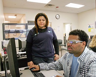 Leon Hopkins of Youngstown looks for work at Mahoning County One Stop in Boardman. With him is Arelis Laviena, One Sop Facilitator.