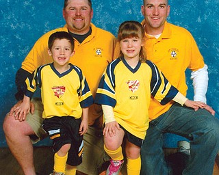 The Saturday suits for these members of the CMIL family are their soccer uniforms. Brothers Ray Cmil III, back left, and Ryan Cmil, back right, coach the St. Charles Soccer Team. On their team are Ray IV and Olivia, 5 1/2-year-old twins of Ray and his wife, Rebecca, of Boardman.