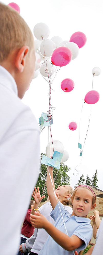 Payton Wrona and her kindergarten classmates  launch balloons in bidding farewell on the students last day at St. Joseph School in Austintown, Friday June 5, 2009.