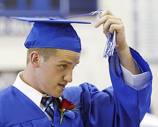 Poland HS grad Gannon Hulea switches the tassle on his cap after recieving his diploma during a Sunday ceremony at the poland HS fieldhouse.