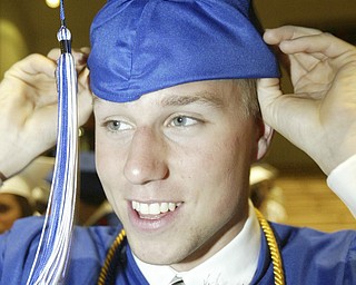 Poland grad Chris Hunt tries on his cap before Sunday commencement ceremony.