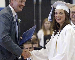Poland BOE member Dave Bennett presents a diploma to Erin Sweeney, one of 220 to receive diplomas at the Sunday ceremony held in the Poland HS fieldhouse.