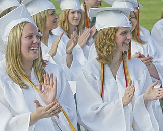Springfield grads Erica Burkey and Ursula Buzzacco applaud during Sunday commencement ceremony.