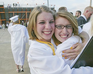 Springfield grads Heather Cozak, left, and Aubrey Bullen hug after Sunday commencement.